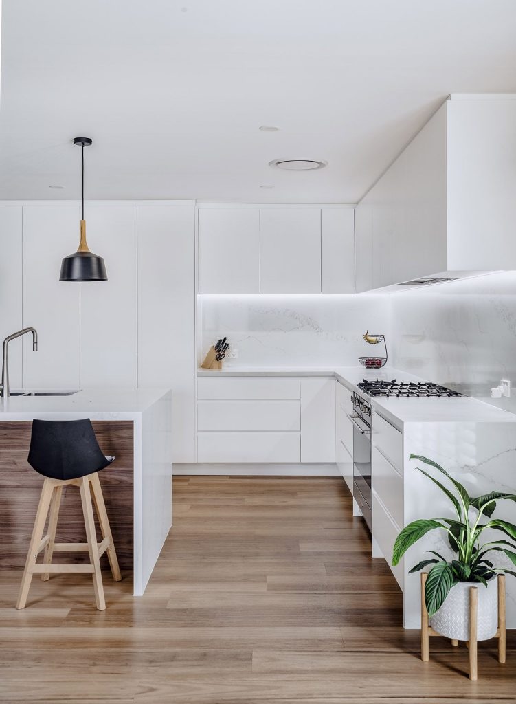 Spacious kitchen renovation with a large island and integrated appliances