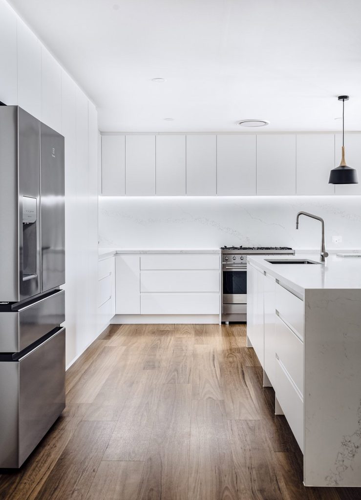Contemporary kitchen with custom cabinetry and premium finishes by iBuild Group