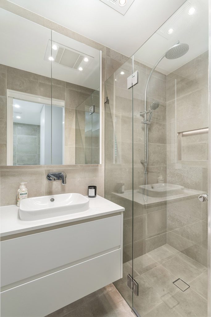 Frameless shower screen, mirrored cabinet and floating vanity powder room
