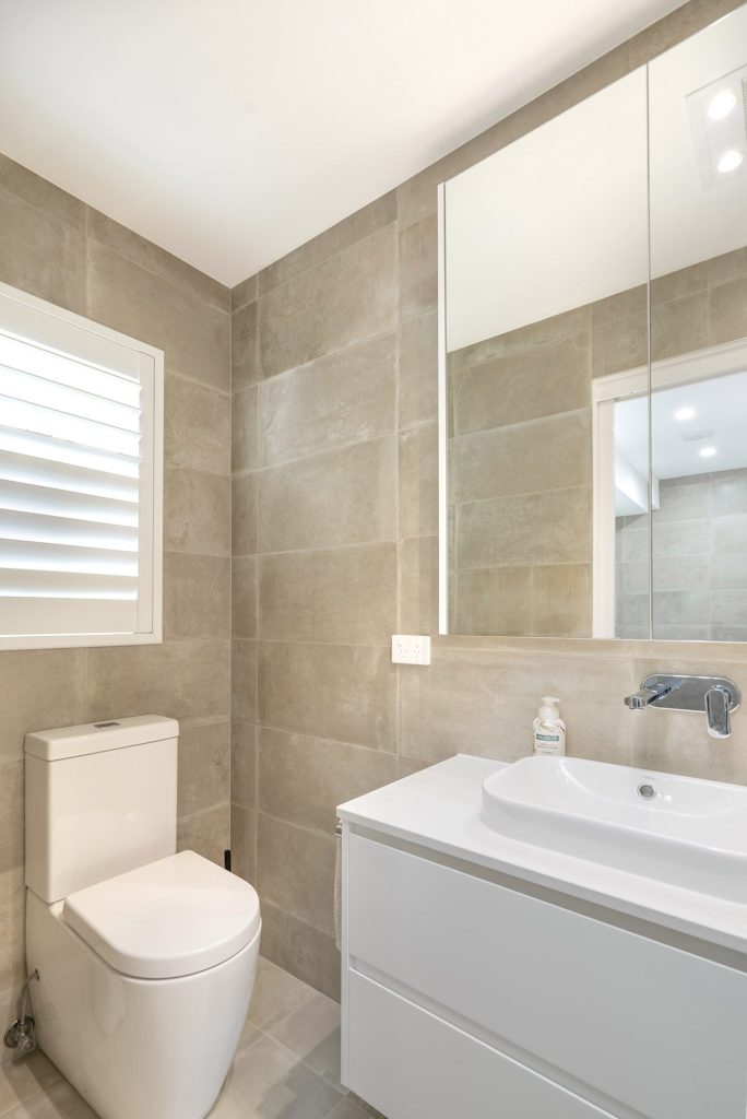 Frameless shower screen, mirrored cabinet and floating vanity powder room