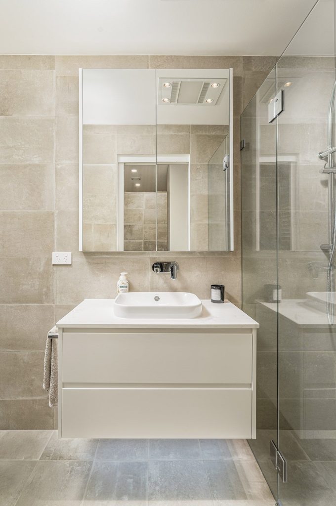 Frameless shower screen, mirrored cabinet and floating vanity powder room