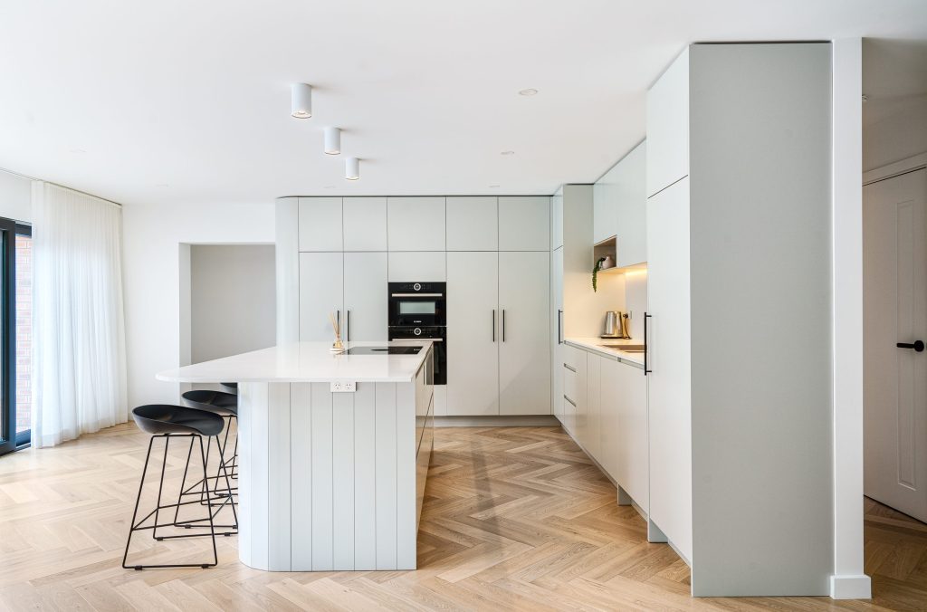 Custom-built kitchen with quality cabinetry, feature lighting and stone surfaces