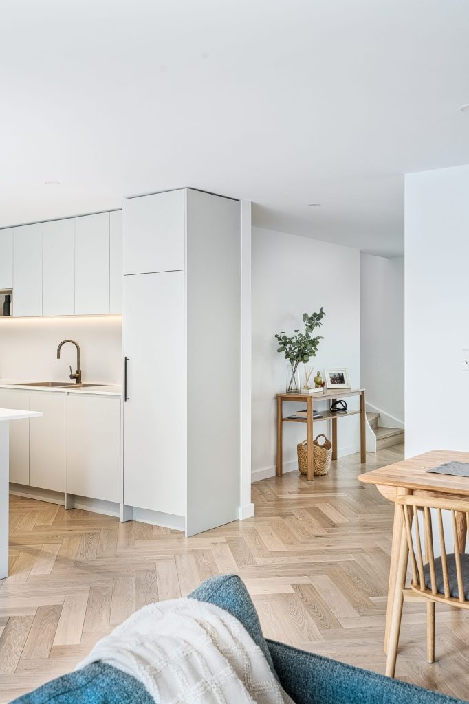 Timber flooring flowing through an open-plan living space