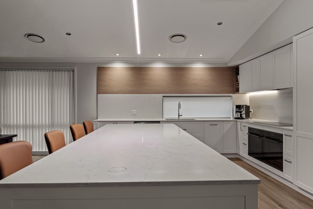 Custom-built kitchen with quality cabinetry, feature lighting and stone surfaces