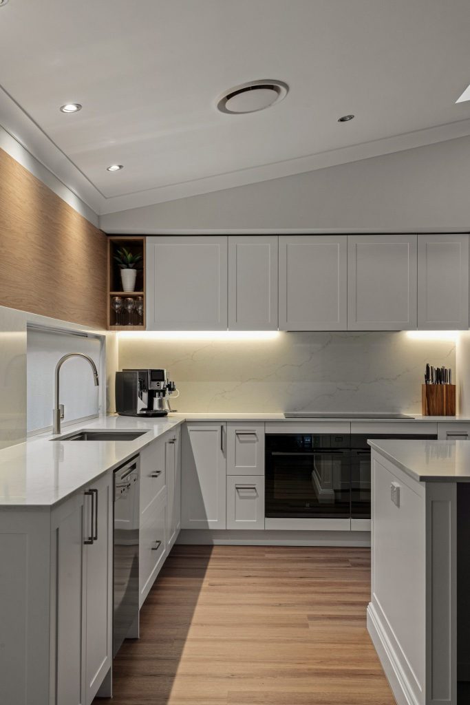 Feature splashback and custom shelving in a modern kitchen