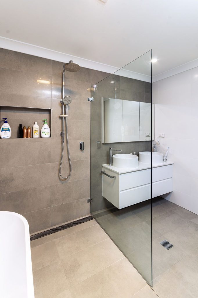 Renovated bathroom featuring a wall-hung vanity and premium fixtures