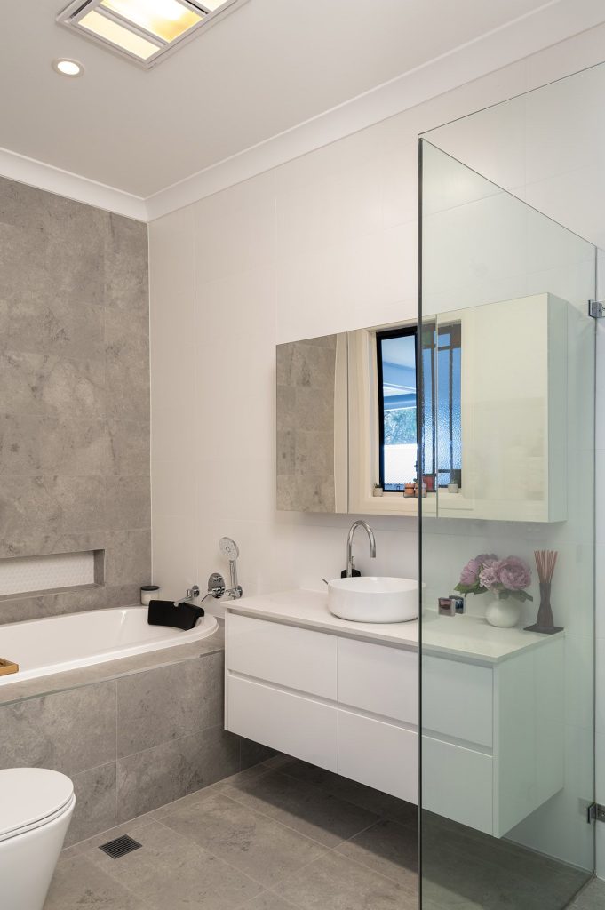 Renovated bathroom featuring a wall-hung vanity and premium fixtures