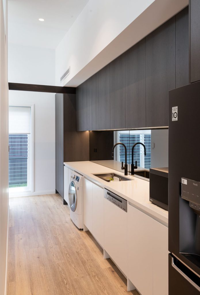 Custom joinery integrating butlers pantry and laundry