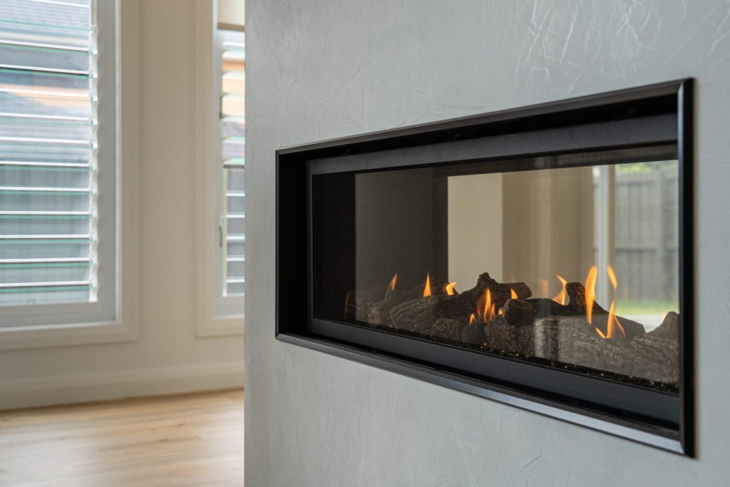 Double sided gas fireplace with textured paint finish