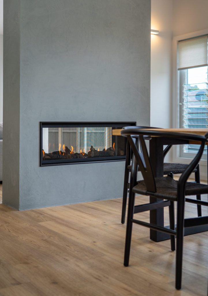 Double sided gas fireplace with textured paint finish