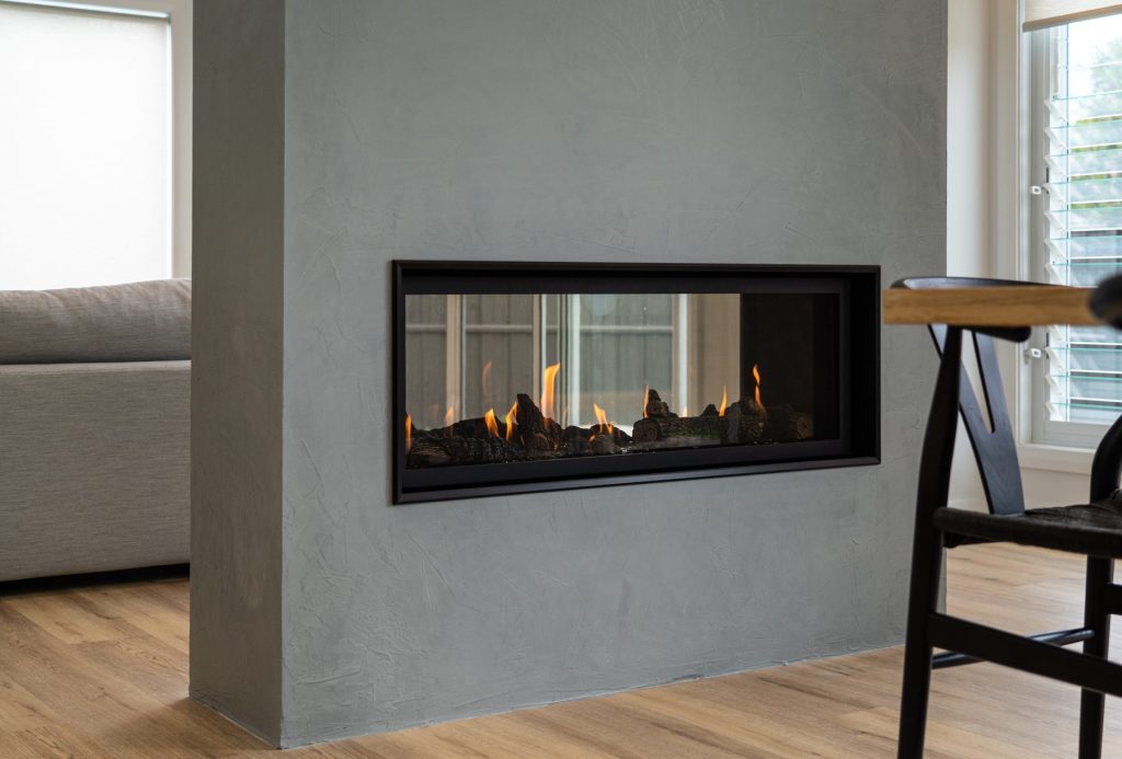 Double sided gas fireplace with textured paint finish