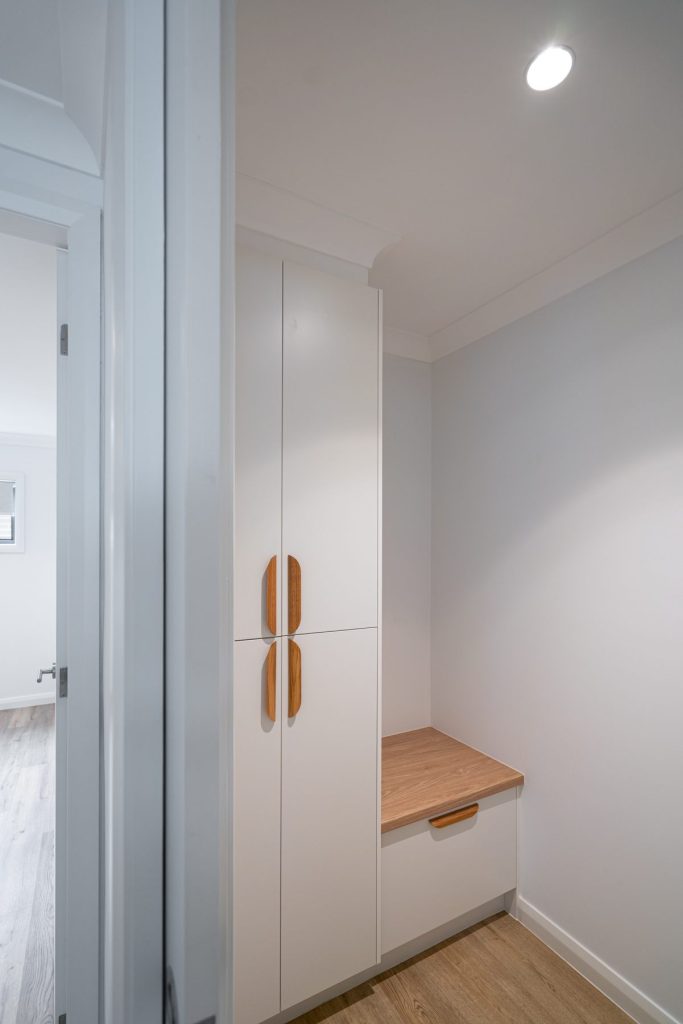 Mudroom from garage with custom storage for school bags and shoes