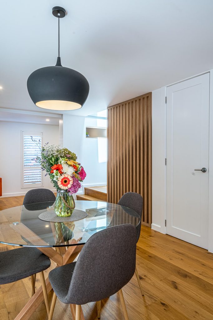 Timber flooring flowing through an open-plan living space