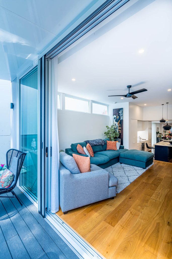 Large stacking doors opening onto the covered architectural custom hoods in Balmain