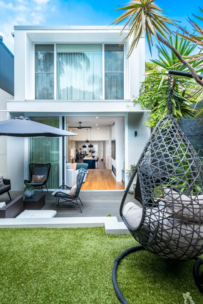 Large stacking doors opening onto the covered architectural custom hoods in Balmain