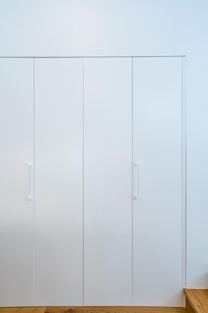 Bifold doors concealing the laundry custom joinery in Balmain