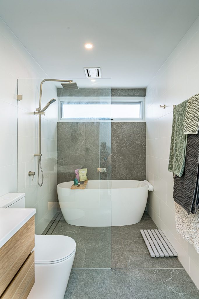 Modern bathroom with freestanding bathtub and custom timber vanity