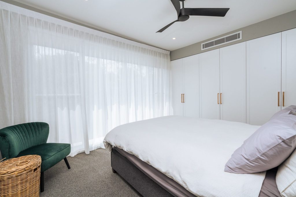 Custom wardrobe joinery in the master bedroom, concealed VRV air-conditioning units by bulkhead