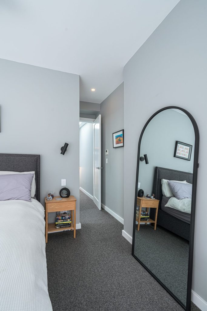 Modern bedroom in the partial rebuild project by iBuild Group Pty Ltd