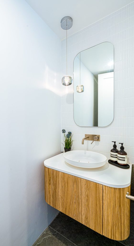 Bright Powder Room with featured lighting and brushed nickel tapware